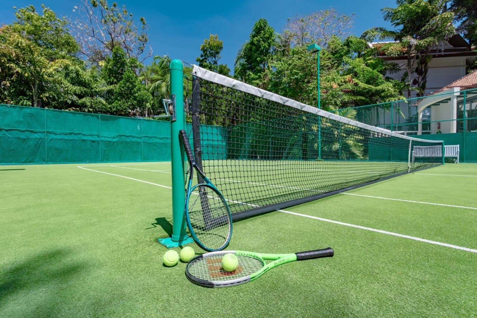 Tennis court at Katamanda Estate surrounded by tropical gardens